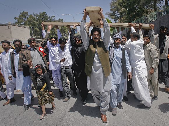 Pakistani Christians carry a cross through the streets of Quetta  while observing Good Friday