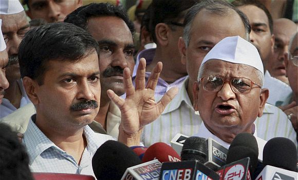 Team Anna member Arvind Kejriwal addresses the media with Hazare