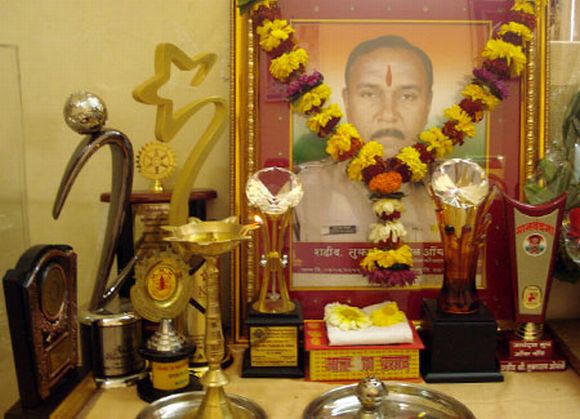 A framed photograph of sub-inspector Tukaram Omble along with several awards received for his bravery at his home in Worli