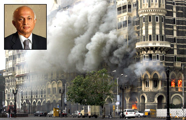The Taj Mahal hotel is seen engulfed in smoke during a gun battle in Mumbai. Inset: Foreign Secretary Ranjan Mathai