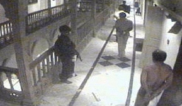 A grab taken from the Taj Hotel CCTV footage shows a terrorist shifting hostages to another room