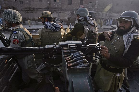 Paramilitary forces patrol the streets of Peshawar, in northwest Pakistan after a NATO airstrike
