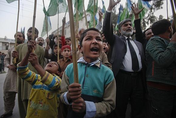 Young supporters of Jamaat-e-Islami, a religious and political party, yell anti-American slogans while protesting in Islamabad against a NATO cross-border attack