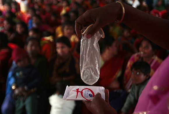 A sex worker demonstrates the use of a female condom during an HIV/AIDS awareness campaign organised by a non-governmental organisation in Siliguri