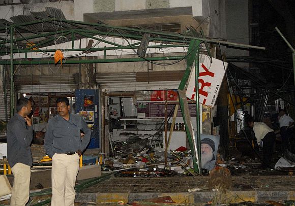 Police gather at the site of a bomb blast at the German Bakery restaurant in Pune on February 13, 2010
