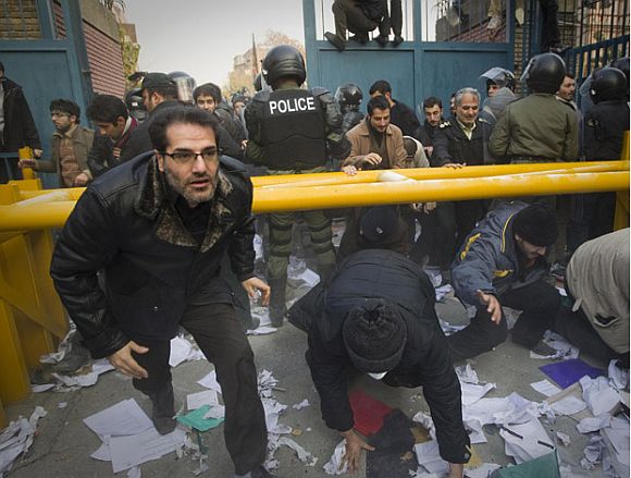 Protesters enter the gate of the British embassy in Tehran