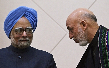 Afghan President Hamid Karzai speaks with Prime Minister Manmohan Singh