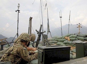 US soldiers from Task Force 'No Fear' 3rd Platoon, Alpha Company, 2-27 Infantry fire a 60mm mortar towards the Taliban position during an early morning firefight in Ghaziabad district at outpost Bari Ari in Kunar, Afghanistan in this picture taken on September 13, 2011