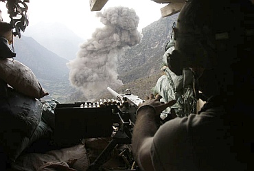 Smoke rises after a US military fighter jet dropped bombs at Taliban positions, as seen from a bunker of the US soldiers from Task Force