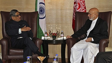 Foreign Minister SM Krishna speaks with Afghanistan's President Hamid Karzai during their meeting in New Delhi