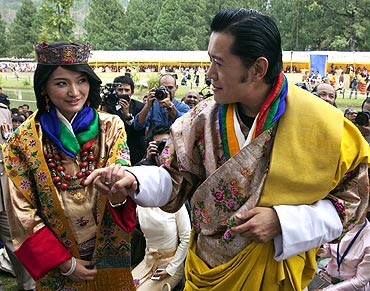 King Jigme Khesar Namgyel Wangchuck holds hands with Queen Jetsun Pema