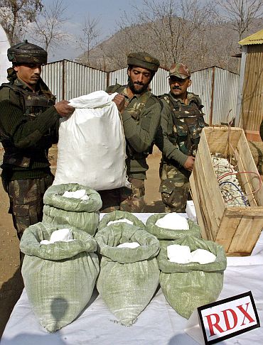 Rashtriya Rifles soldiers display seized RDX from terrorists in a camp near Srinagar