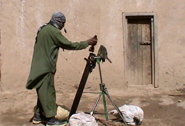 A Pakistan Taliban prepares to fire a weapon