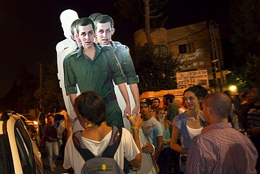 Israeli activists carry cardboard cut-outs of captured Israeli soldier Gilad Shalit outside the residence of Israel's Prime Minister Benjamin Netanyahu in Jerusalem
