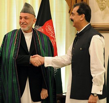 Pakistan PM Gilani with Afghanistan President Hamid Karzai after a meeting in Islamabad