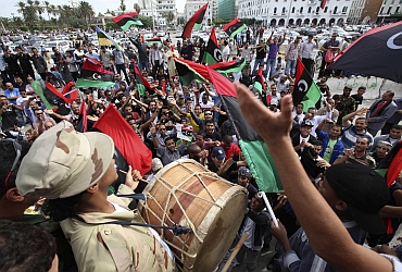 Libyans celebrate at Martyrs square in Tripoli after hearing news of Gaddafi's death