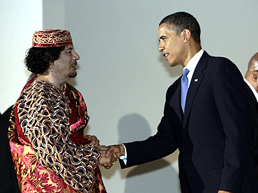 US President Barack Obama shakes hands with Libya's leader Muammar Gaddafi