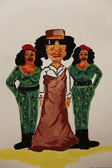 A caricature depicting Libyan leader Muammar Gaddafi (C) with female bodyguards is displayed in a gallery at an exhibition titled Gaddafi's Crimes Exhibition at Old University in Benghazi