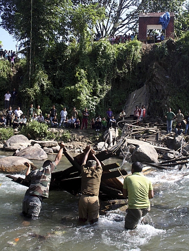 Rescue workers search for bodies at the site of a collapsed bridge at Bijonbari village in Darjeeling district