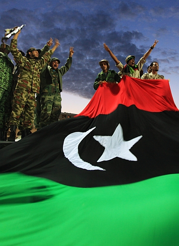 Anti-Gaddafi fighters celebrate Gaddafi's fall