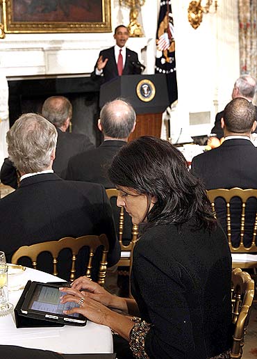 Nikki Haley types on her iPad as US President Barack Obama speaks during a meeting with a bipartisan group of governors in the State Dining Room at the White House in Washington