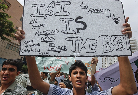 High school students hold placards as they take part in an anti-American demonstration in Karachi
