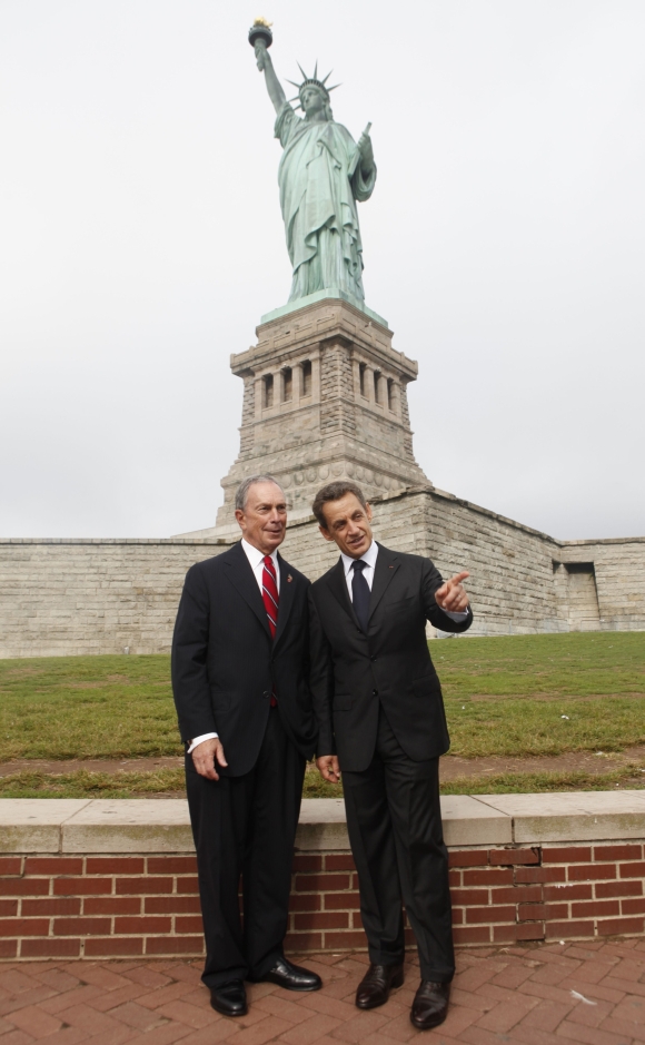French President Nicolas Sarkozy and New York City Mayor Michael Bloomberg stand in front of the Statue of Liberty
