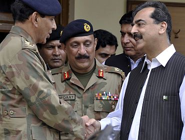 File picture of Pakistan Prime Minister Gilani shaking hands with army chief General