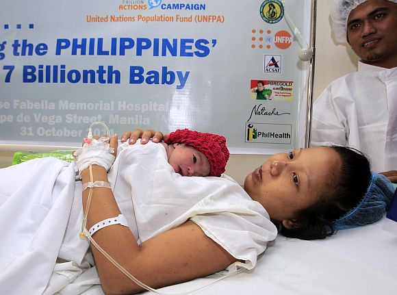 Filipina mother Camille holds her newborn baby girl