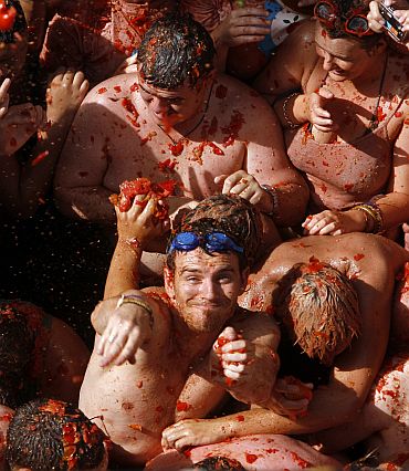 Revelers battle with tomato pulp during the annual Tomatina in the Mediterranean village of Bunol, near Valencia