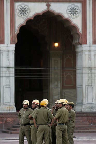 Police officers stand guard inside Jama Masjid after the  blast