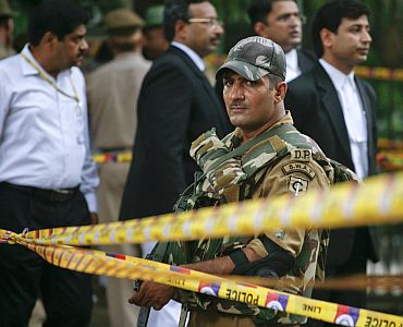 A Delhi police personnel keeps vigil after cordoning off the site of the blast
