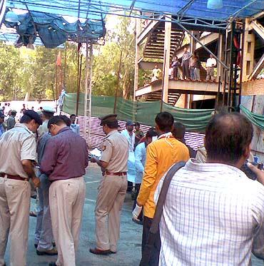 Police personnel, relatives and medical crew throng the entry to the emergency ward at the hospital