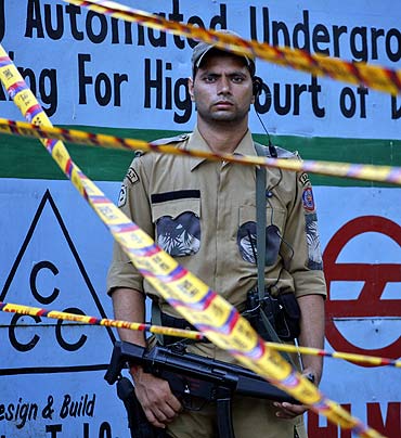 A special weapons and tactics member of the Delhi police force stands guard outside the high court