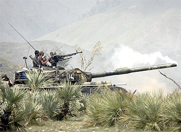 Soldiers fire at targets from their base camp in Tora Warai along the Pakistan-Afghanistan border