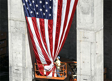 A worker holds up a US flag at the World Trade Centre construction site in New York