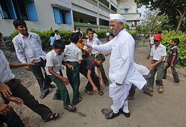 Hazare interacts with school children in his village