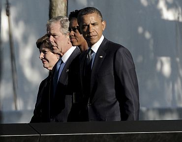 US President Barack Obama, first lady Michelle Obama, former president George W Bush and Mrs Laura Bush walk past the North Pool at the National September 11 Memorial during tenth anniversary ceremonies at the World Trade Center site in New York