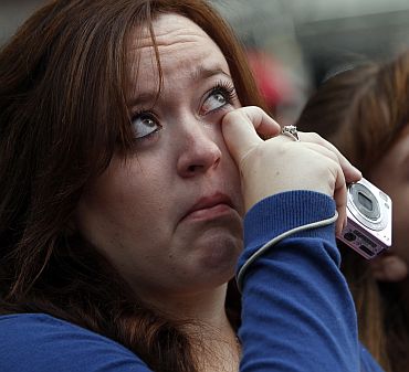 People react during ceremonies marking the 10th anniversary of the 9/11 attacks on the World Trade Center, in New York