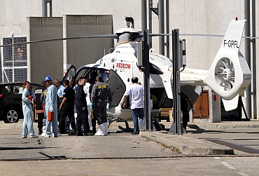 Rescue services evacuate a person injured after an explosion at the French nuclear waste treatment site of Marcoule