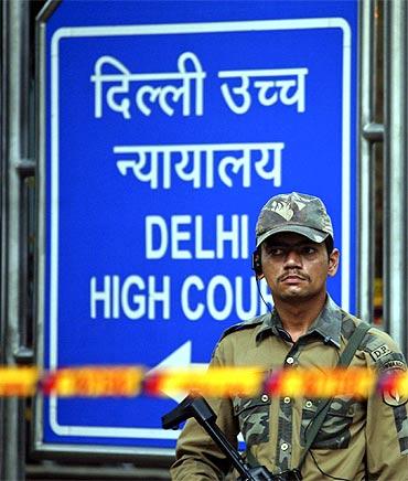 A police commando stands guard outside the Delhi high court after the blast