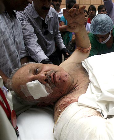 A man, who was injured by the bomb blast outside Delhi high court, is carried on a stretcher to a hospital