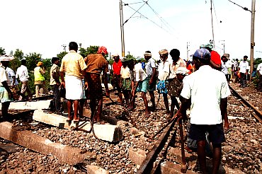 Railways workers clearing the debris at the site