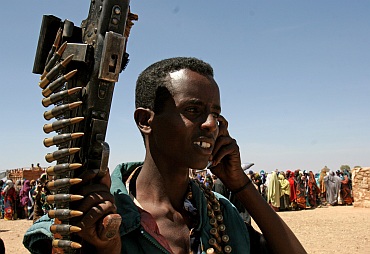 A Somalian militant talks on his mobile phone in Rabdure district, 400 km (248 miles) west of Somalian capital Mogadishu