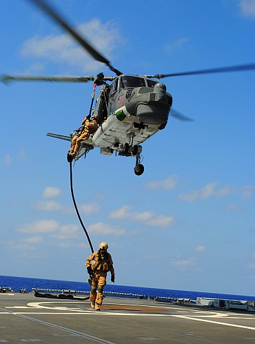 Estonian marines 'fast-rope' from a Sea Lynx MK 88 helicopter onto the helicopter flight deck aboard the German Frigate 'Hamburg' off the coast of Djibouti