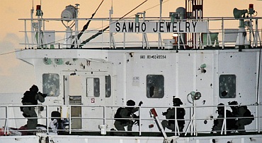 South Korean naval Special Forces take up positions during an operation to rescue crew members on the Samho Jewelry vessel in the Arabian Sea