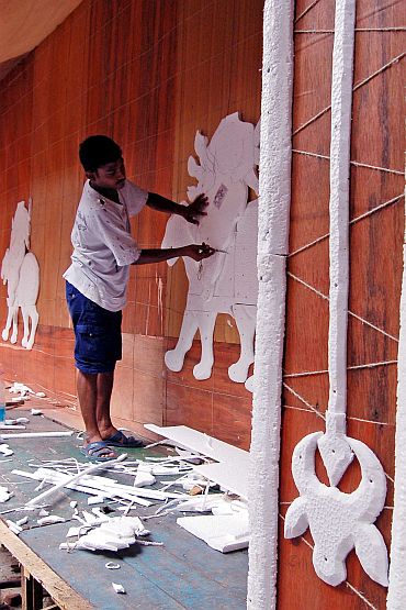 An artist busy decorating the pandal of the 74 Pally Sarbojonin Durgotsab in Kolkata