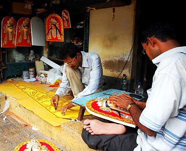 Kumartuli artists busy creating the wondeful accessories which further beautify Maa Durga's idol and the pandal