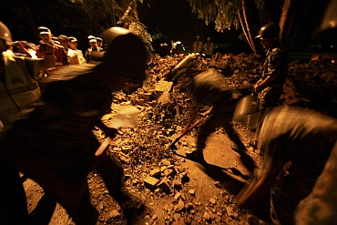 Members of the Nepalese army clear debris after the quake