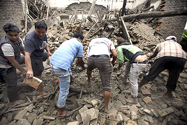 Residents search for casualties in the ruins of a quake-damaged house at Lokanthali in Bhaktapur